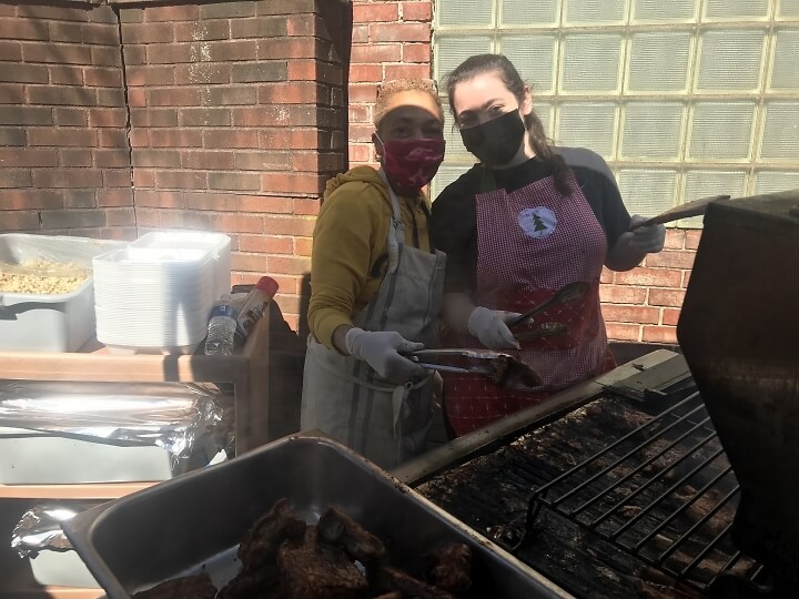 Carmelita Taylor and Lydia Cooper, two volunteers at CSK, working the grill.