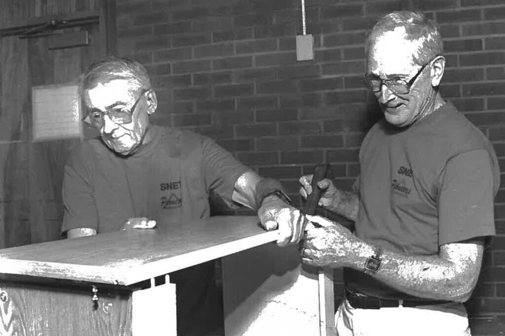 Black and White photo of Volunteers building something at CSK in the past